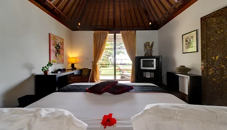 Elegant Bali bedroom with garden view at Majapahit Villa Raj
