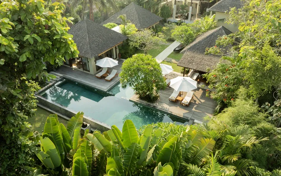 The bedrooms look out to the tropical garden and pool at Villa Nelayan