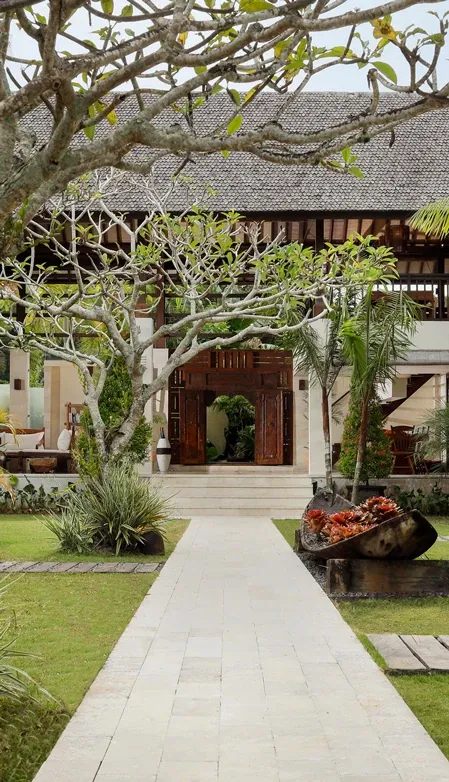 The javanese entrance to the villa leads to an open air common area at Villa Nelayan