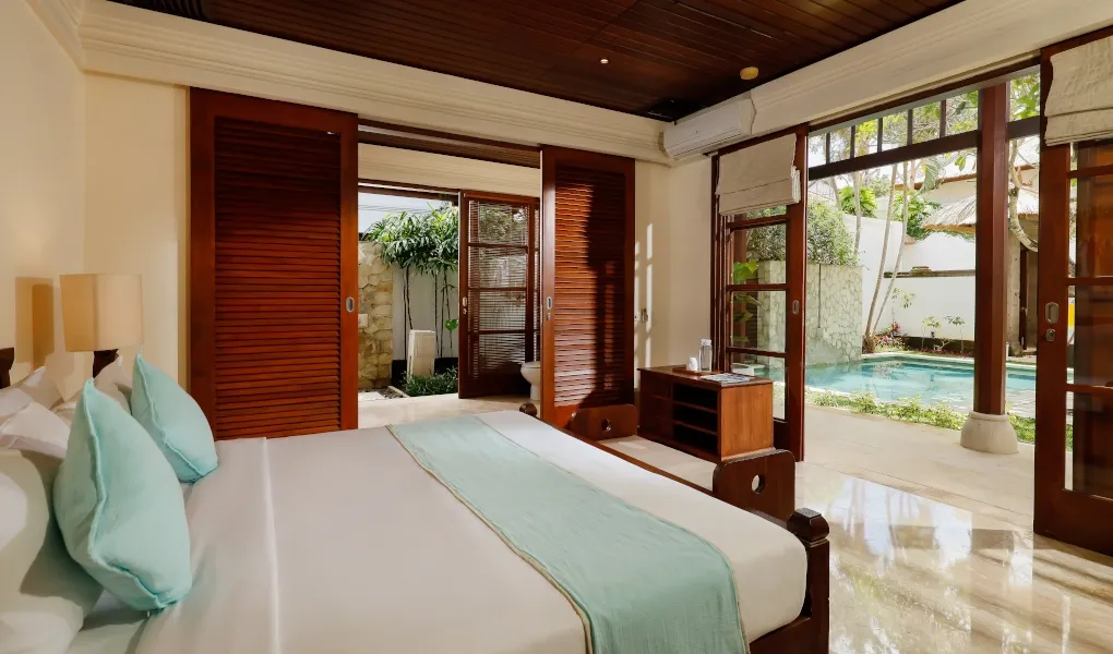 A bedroom with a view of a private plunge pool at Villa The Seven