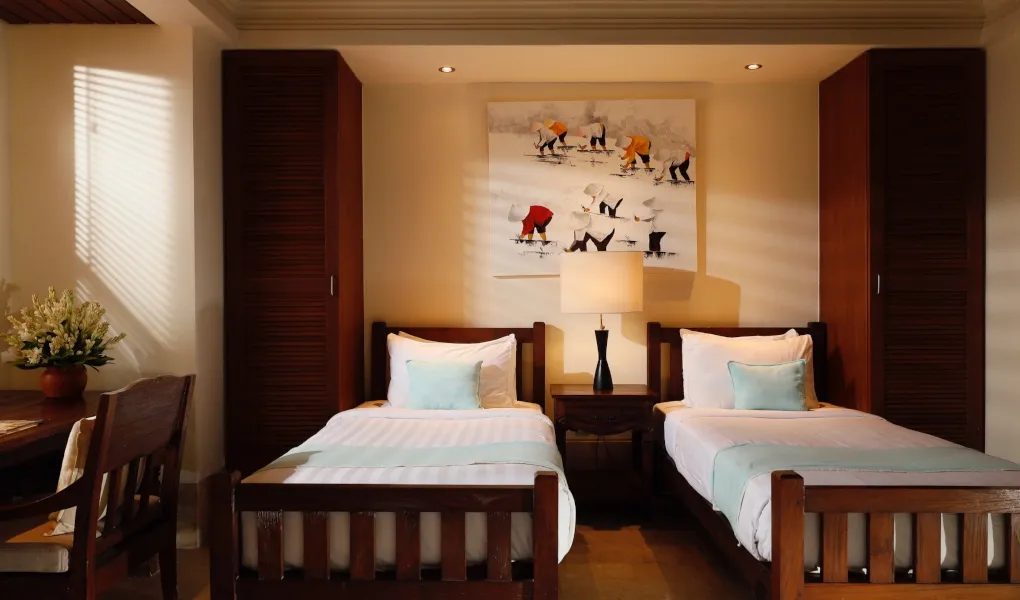 Elegant bedroom with twin beds and a nightstand at Villa The Seven