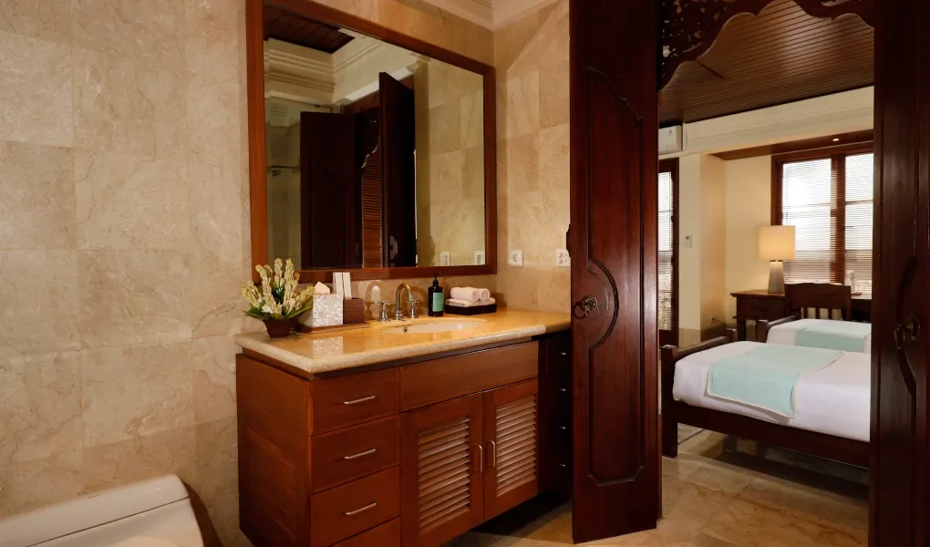 Ensuite bathroom with a vanity and a peek of a twin bedroom at Villa The Seven