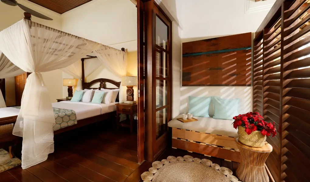 Tropical bedroom with a canopy bed and a daybed on balcony at Villa The Seven