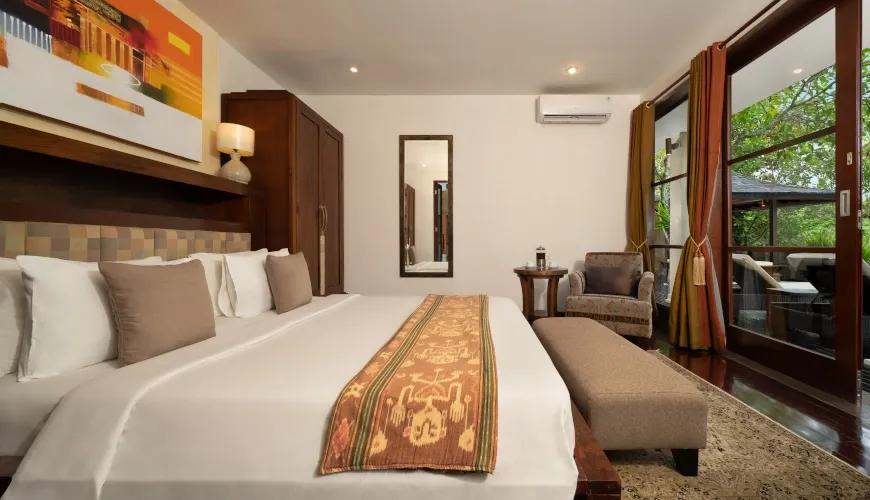 Guest Suite with Large Windows and Tropical Greenery Views at Villa Ambiente