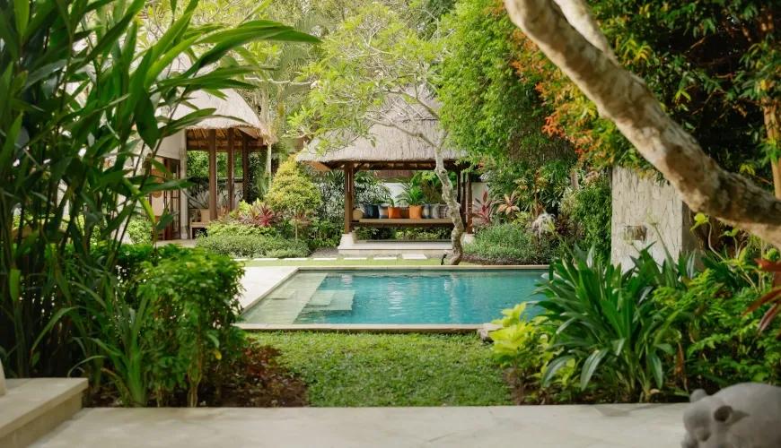 Lush garden pool area and gazebo at Villa Ohm