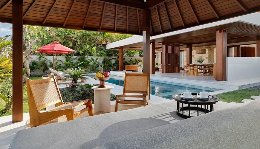 Comfortable villa lounge gazebo featuring natural wood chairs and cushioned daybed overlooking the stunning private pool at Amarta Beach Retreat 2BR Villa