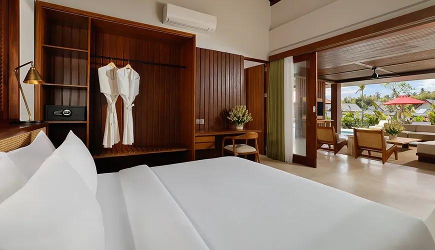 Spacious master bedroom featuring a comfortable king-size bed and open access to the luxurious outdoor living area at Amarta Beach Retreat 2BR Villa