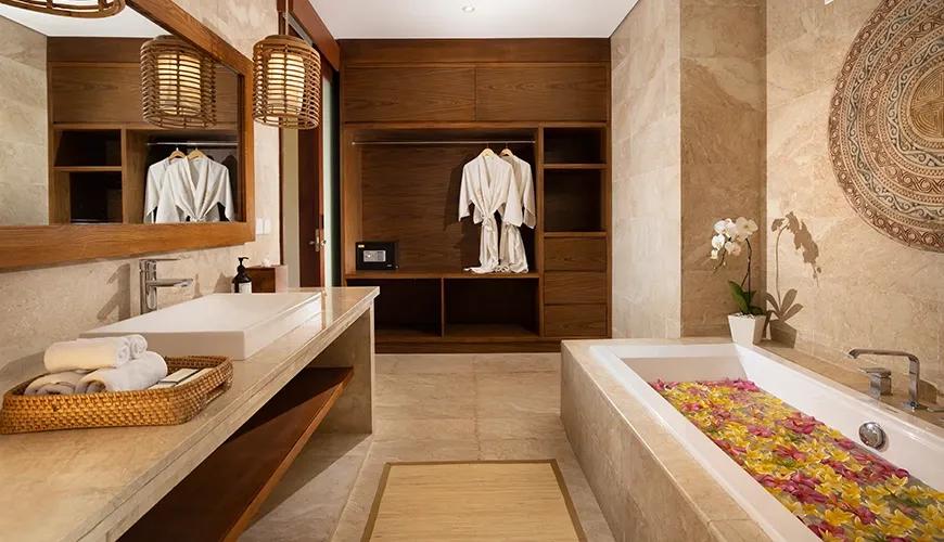 Luxurious Balinese bathroom with a flower-filled tub and modern decor at amarta beach retreat