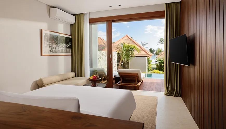 Luxurious master bedroom in a private villa featuring sliding doors that open to a refreshing pool view at Amarta Beach Retreat