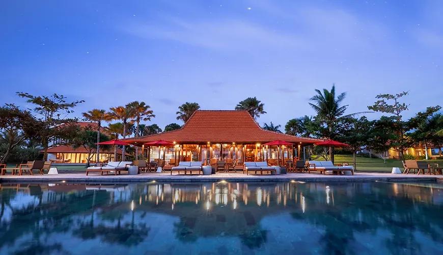 Luxurious outdoor restaurant by a pool at a beachfront resort in amarta beach retreat