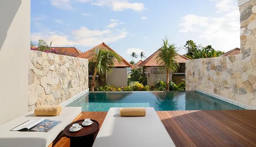 Stunning private villa pool deck with comfortable sun loungers overlooking the beautiful tropical landscape at Amarta Beach Retreat