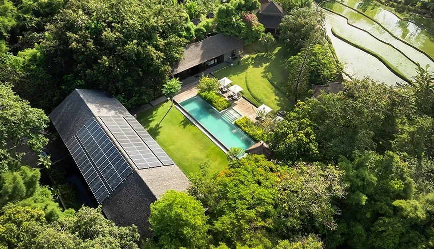 Aerial view of a luxurious property amidst lush greenery at Amita Villa