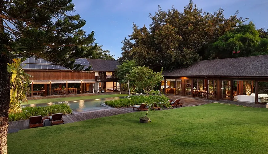 Beautiful long swimming pool with surrounding greenery at Amita Villa