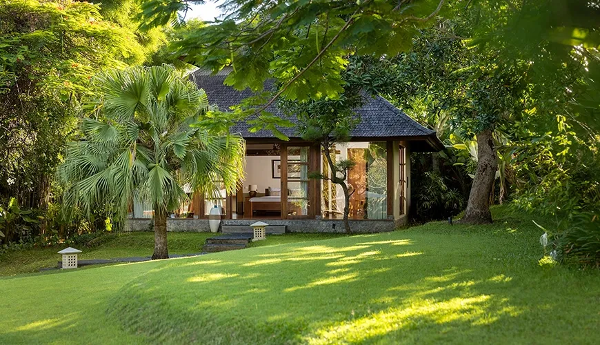 Beautiful outdoor space featuring vibrant flowers and manicured lawn at Amita Villa