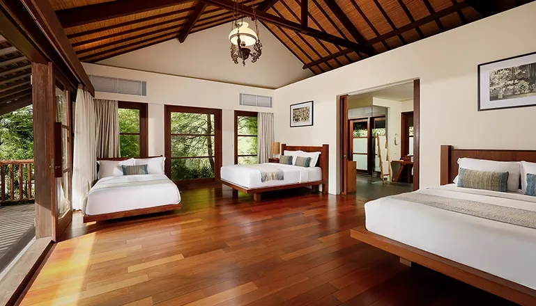Serene bedroom ambiance with warm tones and simple furnishings at Amita Villa