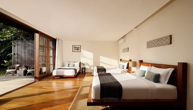 Spacious bedroom featuring warm lighting and a comfortable bed at Amita Villa