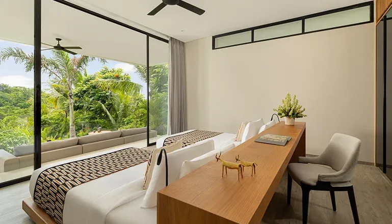 Beautiful bedroom featuring two beds and a modern work desk at Arita Villa