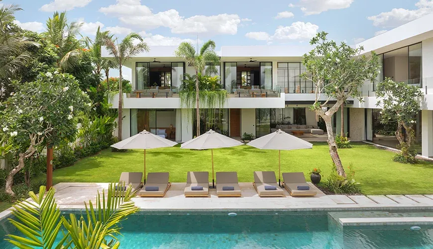 Bright and airy pool area surrounded by lush greenery at Arita Villa