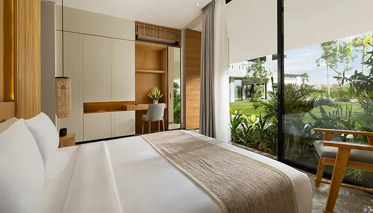 Bright bedroom with a king bed and a built-in desk area at Arita Villa