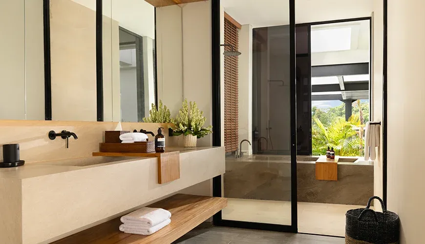 Elegant bathroom with double sinks and a walk-in shower at Arita Villa
