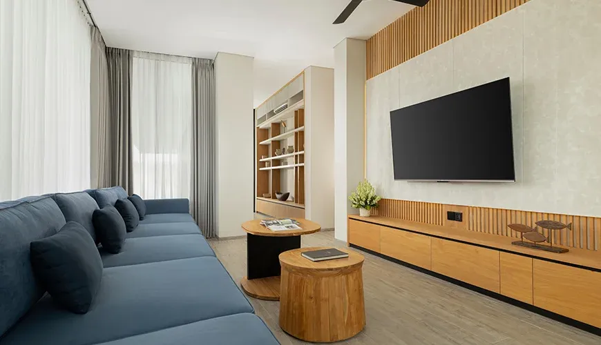 Elegant entertainment room with a large television and bookshelf at Arita Villa