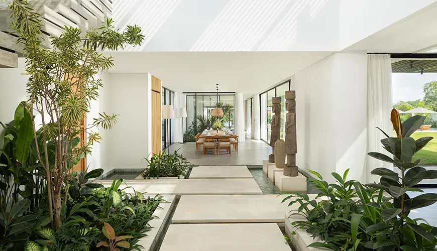 Inviting villa entrance with stone path and lush plants at Arita Villa
