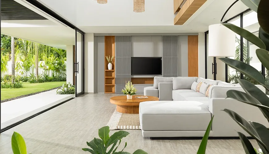 Modern living room with sectional sofa and garden access at Arita Villa