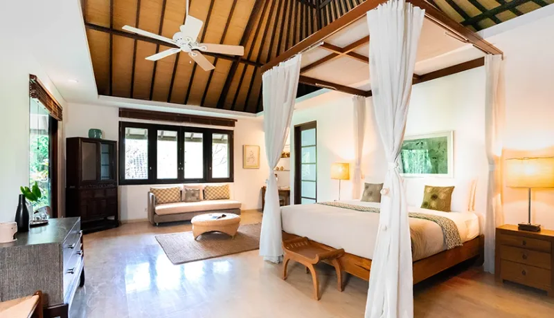 Spacious master bedroom featuring a four-poster bed and traditional vaulted ceiling at Asraya Villa