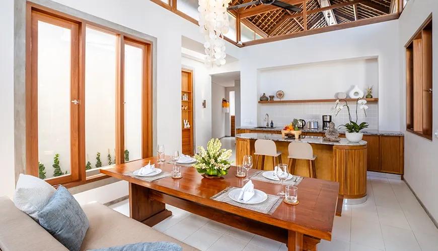 Balinese open-plan kitchen with wooden dining table and bar at bumbak park
