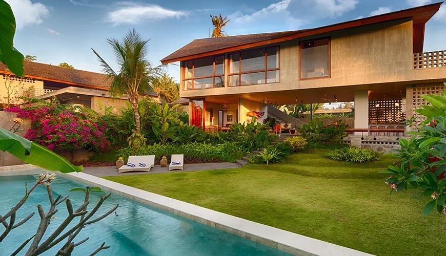 Contemporary villa features unique architecture, refreshing pool, and expansive green lawn at caSabama