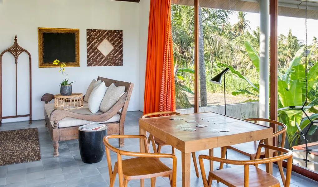 Cozy living space with wooden furniture and lush plants at casaBama