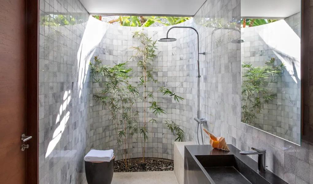 Modern bathroom with natural light and an outdoor shower at casaBama