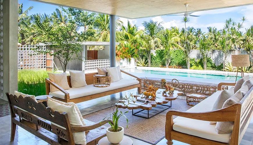 Open-air living area features comfortable seating and a beautiful poolside view at caSabama