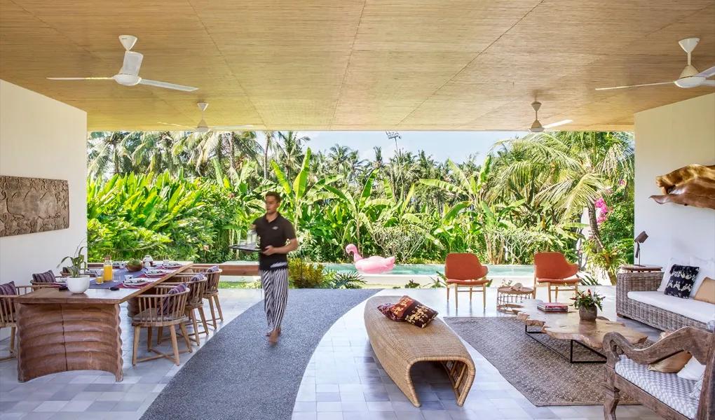 Open-air living space with pool view and tropical backdrop at casaBama