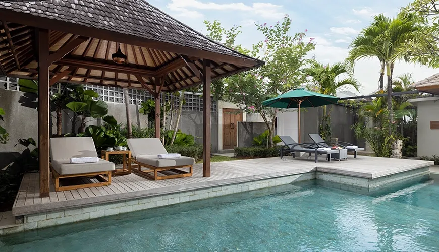 Beautiful swimming pool area with shaded gazebo and loungers at Christie Villa