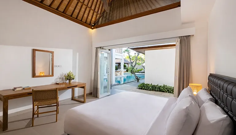 Comfortable bedroom with a large bed and modern wooden decor at Chrisite Villa