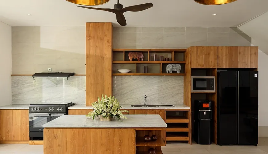 Modern kitchen with wooden cabinets and marble island at Christie Villa