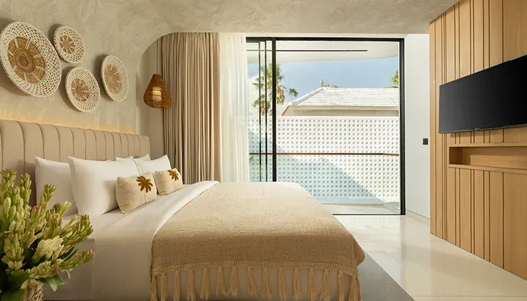 Bright bedroom with a large bed and light wooden accents at Fenta Villa