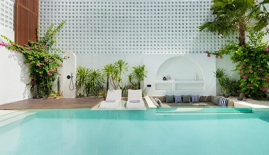 Expansive swimming pool with an in-water lounge area at Fenta Villa