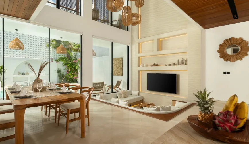 Luxury modern living room with sunken lounge and open dining area at Fenta Villa