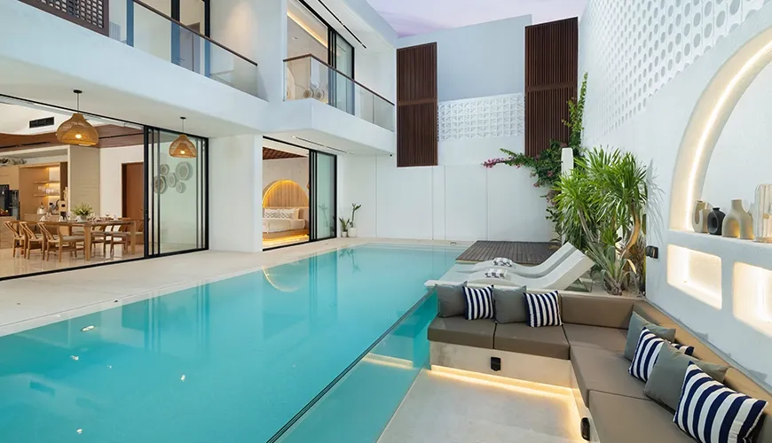 Modern villa pool area with integrated sunken lounge and lush surroundings at Fenta Villa