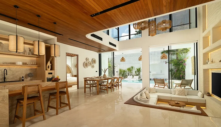 Spacious modern living room with sunken lounge and pool access at Fenta Villa