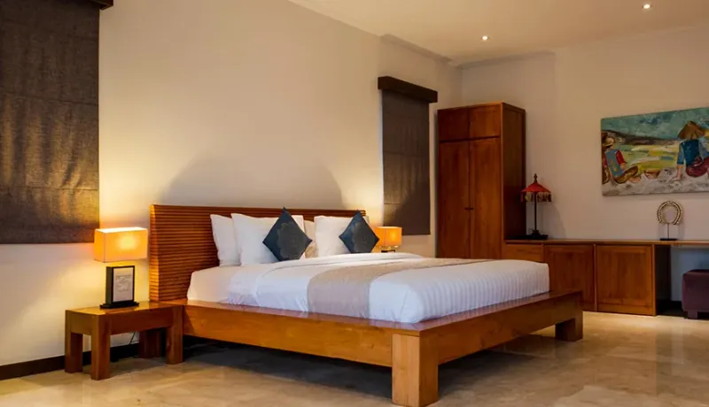 Cozy Bali bedroom with traditional wooden interior design at Istana Putih VIlla