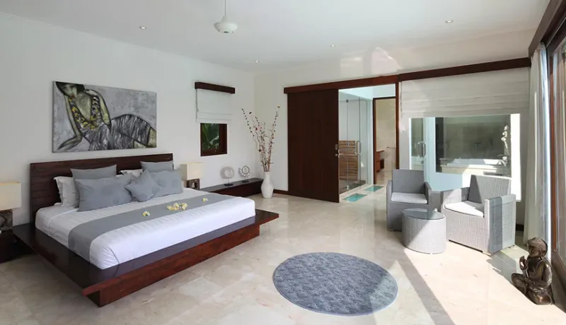 Luxurious white master bedroom with jacuzzi at Istana Putih Villa
