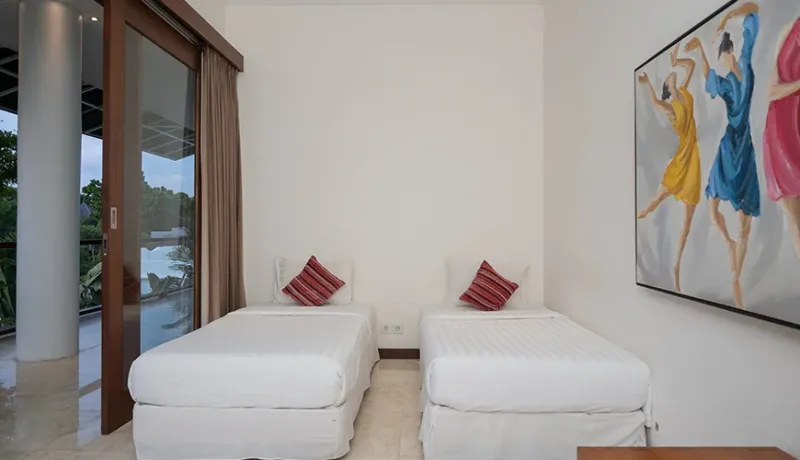 Modern Bali twin bedroom with balcony and art at Istana Putih Villa