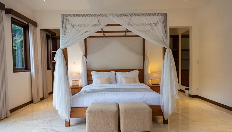 Spacious Bali villa bedroom with canopy king bed at Istana Putih Villa