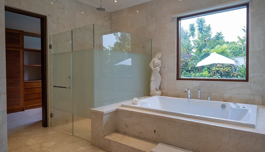 Elegant ensuite bathroom featuring jacuzzi and garden shower at Istana Putih Villa