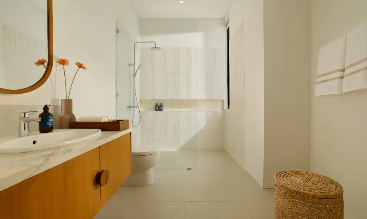 Clean, bright bathroom with modern fixtures and walk-in shower at Kalem Canggu