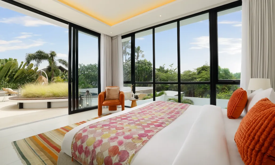 Luxury master bedroom with pool access and lush tropical views at Kalem Canggu