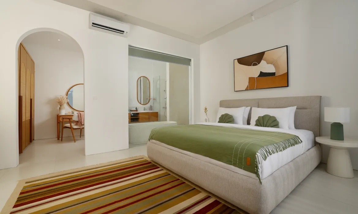 Master bedroom suite with connected private bathroom and stylish decor at Kalem Canggu